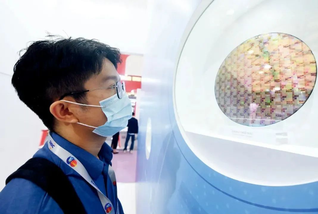 10月14日,参观者在2020中国国际半导体博览会上观看中芯国际代工生产的芯片。图/IC